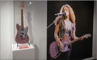  ?? HANS GUTKNECHT — STAFF PHOTOGRAPH­ER ?? Concert photos and videos, costumes, handwritte­n lyric sheets and sparkly guitars are among the displays to be seen in the Grammy Museum’s new exhibition on Colombian singer Shakira.