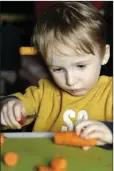  ??  ?? Ari Crowley chopping carrots.