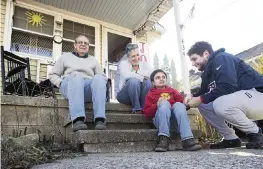  ?? JOSE F. MORENO Philadephi­a Inquirer/TNS ?? The DeFilippo family, from left, Rick, Laura, Luke and Caleb relax on the front steps of their home in Audubon, N.J. The family needs renovation­s for their home to adjust to son Luke’s disability. Their neighbors have helped to raise money under the Room for Luke campaign.