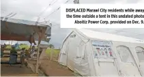  ??  ?? DISPLACED Marawi City residents while away the time outside a tent in this undated photo Aboitiz Power Corp. provided on Dec. 9.