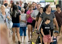  ?? PHOTO: CHRIS MCKEEN/STUFF ?? Shoppers queued outside Westfield Albany stores before they opened at 10am yesterday.