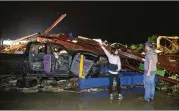  ?? TOM FOX / THE DALLAS MORNING NEWS ?? Ernestine Cook of Canton points out the damage to Michael Search of Henderson as they inspect damage at a Canton car dealership.