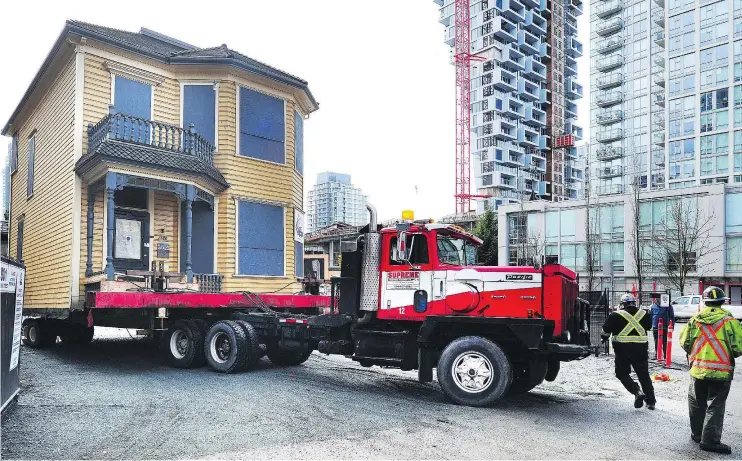  ??  ?? Historic Leslie House was relocated Tuesday to a spot across the lane from its home at Hornby and Pacific and will stay there while the site is being redevelope­d.