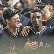  ?? Matias J. Ocner Miami Herald ?? DEE GORDON cries after hitting a homer and is consoled by Derek Dietrich in an emotional game for the Marlins after the death of Jose Fernandez.