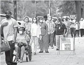  ?? MICHAEL HOLAHAN/THE AUGUSTA CHRONICLE ?? Voters pack an election site this week in Augusta, Georgia. Black Georgians are flocking to the polls and waiting in lines for several hours to cast their ballots in early voting.