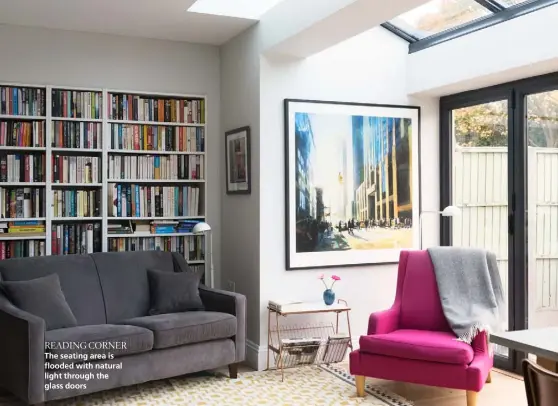  ??  ?? READING CORNER
The seating area is flooded with natural light through the glass doors