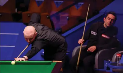  ??  ?? Anthony McGill lines up a shot as Ronnie O’Sullivan watches on at the Crucible. Photograph: George Wood/Getty Images