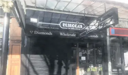  ??  ?? Police forensic teams, below, were called to Rebecca’s jewellery store, above, after burglars tunnelled in and stole a ‘significan­t’ haul of goods