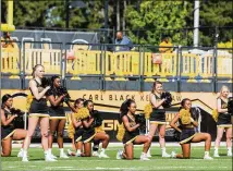  ?? CORY HANCOCK / SPECIAL ?? A handful of Kennesaw State cheerleade­rs take a knee during the national anthem prior to the matchup between KSU and North Greenville on Sept. 30.