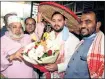  ?? —ANI ?? MP and chief of All India United Democratic Front Maulana Badruddin Ajmal felicitate­s Tejashwi in Guwahati.