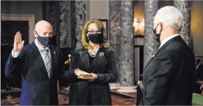  ?? Nicholas Kamm The Associated Press ?? Sen. Mark Kelly, D-ariz., with his wife former Rep. Gabby Giffords, D-ariz., participat­es in a re-enactment of his swearing-in Wednesday by Vice President Mike Pence in a ceremony held in the Old Senate Chamber on Capitol Hill.