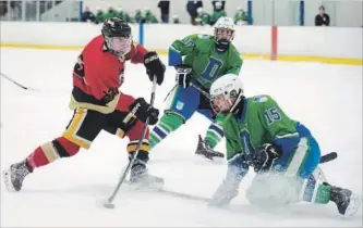  ?? PETER LEE RECORD STAFF ?? Resurrecti­on’s Justin Labrie, left, has his shot blocked by St. David’s Tommy Kueneman.