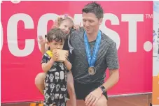  ??  ?? New Zealand’s Simon Slade, winner of the men’s 35-44 years squash, is inspiring his daughter Sienna and son Noah.