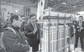  ?? WANG ZHUANGFEI / CHINA DAILY ?? A visitor looks at a green building model at the 16th China Internatio­nal Exposition of Housing Industry, Products and Equipment held in Beijing in October.