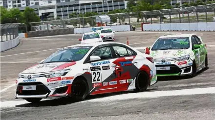  ??  ?? Race cars battling it out for top position at the final leg of Vios Challenge of Toyota Gazoo Racing festival in Technology Park Malaysia.