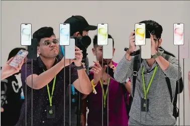  ?? JEFF CHIU/AP PHOTO ?? The iPhone 15 phones are shown during an announceme­nt in September of new products on the Apple campus in Cupertino, Calif.
