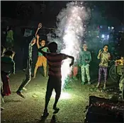  ?? ALTAF QADRI / AP ?? Children play with firecracke­rs during Diwali celebratio­ns in New Delhi, India, Thursday.