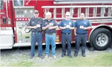  ?? SPECIAL TO THE EXAMINER ?? Trent Lakes Firefighte­rs Glenn Gillam, Don Reesor, John Harvey, and Mark Vargus served sausages and hamburgers at the Community Care Harvey senior’s picnic. They display the File of Life compliment­s of Chemung Lake Lions Club, Trent Lakes and Selwyn...