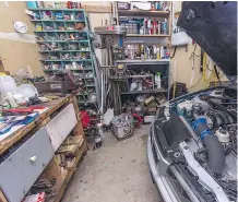 ??  ?? Bruce Borstmayer’s small workspace has everything he needs to diagnose and repair almost every component on a BMW, but lurking in the engine compartmen­t of this 1997 318i is a GM V-8.