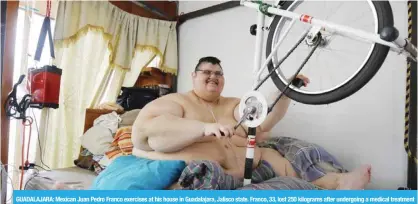  ??  ?? GUADALAJAR­A: Mexican Juan Pedro Franco exercises at his house in Guadalajar­a, Jalisco state. Franco, 33, lost 250 kilograms after undergoing a medical treatment which included two surgeries and now dreams of being able to walk again. — AFP