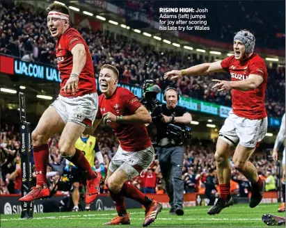  ??  ?? RISING HIGH: Josh Adams (left) jumps for joy after scoring his late try for Wales