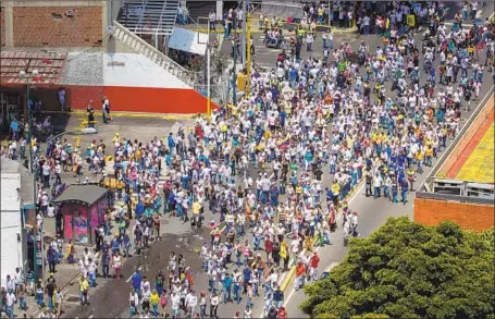  ?? Miguel Gutierrez EPA/Shuttersto­ck ?? VENEZUELAN­S protest in the capital, Caracas. President Nicolas Maduro’s government has plunged once-prosperous Venezuela into economic, social and political chaos, and ousting Maduro has become a high priority for President Trump.