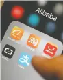  ?? ANTHONY KWAN/BLOOMBERG ?? The icons for Alibaba Group Holding Ltd. applicatio­ns Alibaba.com.