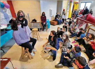 ?? NICK GRAHAM / STAFF ?? Jody Cole, from American Hair Company, cuts hair to be donated to a national organizati­on that converts gifted locks into wigs for the ailing. Several Madison Elementary School students and teachers donated their hair Monday to help others who may need it.