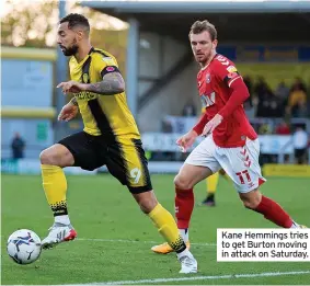  ?? ?? Kane Hemmings tries to get Burton moving in attack on Saturday.