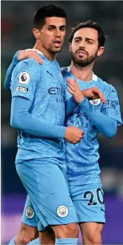  ??  ?? JOY FOR JOAO
Scorer Cancelo celebrates with Bernardo Silva and,
below, Sterling makes it 5-0