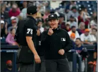  ?? (AP/Jeff Roberson) ?? Umpires Jen Pawol (right) and Edwin Jimenez (75) talk Saturday just prior to the start of a spring training baseball game between the Washington Nationals and the Houston Astros in West Palm Beach, Fla. Pawol took a big step toward breaking the gender barrier for Major League Baseball umpires when she became the first woman in 17 years to work a big league spring training game.