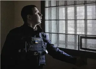  ?? IVOR PRICKETT/THE NEW YORK TIMES ?? Andriy Andryushch­enko, a nightclub director before the invasion, stands Feb. 16 in the cell where he was detained by Russians in 2022 in Kherson, Ukraine. Andryushch­enko said he was tortured for 47 days at the prison where the former mayor of Kherson, Ihor Kolykhaev, was held.