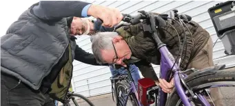  ??  ?? James McGuiness having his bike marked by the new Telesis machine by crime prevention officer Jim Fox.