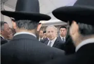  ?? Eugene Hoshiko / Associated Press ?? Israeli Prime Minister Benjamin Netanyahu meets rabbis at the Ohel Moshe synagogue in Shanghai.