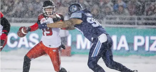  ?? ANDRE RINGUETTE/GETTY IMAGES ?? Stampeders QB Bo Levi Mitchell is sacked by Clayton Laing of the Argonauts during the first quarter of the 105th Grey Cup in Ottawa on Sunday.