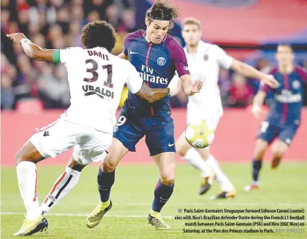  ?? AFP PHOTO ?? Paris Saint-Germain’s Uruguayan forward Edinson Cavani (center) vies with Nice’s Brazilian defender Dante during the French L1 football match between Paris Saint-Germain (PSG) and Nice (OGC Nice) on Saturday, at the Parc des Princes stadium in Paris.