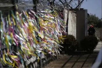  ?? Lee Jin-man/Associated Press ?? Ribbons with messages wishing for peace between the two Koreas adorn wire fences Sunday at the Imjingak Pavilion in Paju, South Korea.