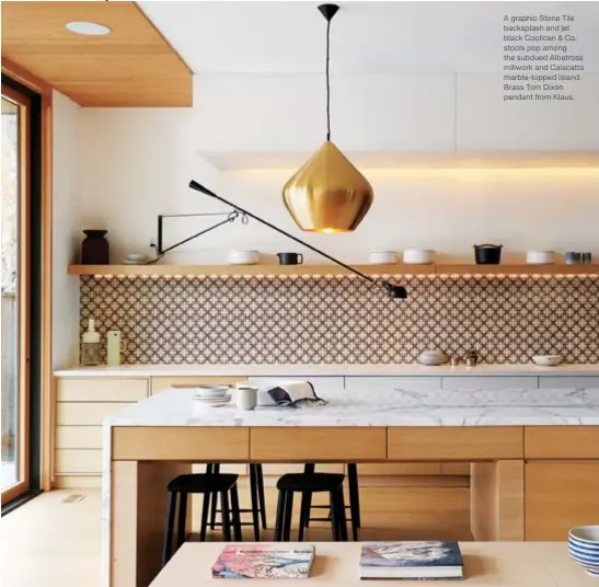  ??  ?? A graphic Stone Tile backsplash and jet black Coolican & Co. stools pop among the subdued Albatross millwork and Calacatta marble-topped island. Brass Tom Dixon pendant from Klaus.