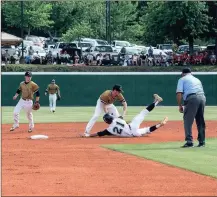  ?? TIM GODBEE / For the Calhoun Times ?? Calhoun shortstop Austin Trammell (center) tags out North Hall’s Reese Olson on a stolen base attempt in Game 1.