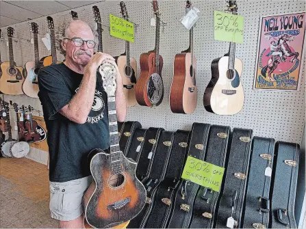  ?? CLIFFORD SKARSTEDT/EXAMINER FILE PHOTO ?? Owner Don Skuce of Ed's Music reflects inside his store on July 20, 2011 as he prepared to close it for good. Mr. Skuce died Sunday.