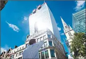  ??  ?? This file photo shows a man reacts to a shaft of intense sunlight reflected from the glass windows of the new ‘Walkie Talkie’ tower in central London on Aug 30, 2013. (AFP)