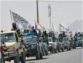  ?? — AFP ?? Taliban fighters atop Humvee vehicles parade along a road in Kandahar on Wednesday to celebrate the US withdrawal of all its troops out of Afghanista­n.