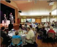  ?? DAN SOKIL — DIGITAL FIRST MEDIA ?? Montgomery County Commission­er Ken Lawrence, holding microphone, speaks to a luncheon for centenaria­ns hosted by the Montgomery County Office of Aging and Adult Services on Thursday.