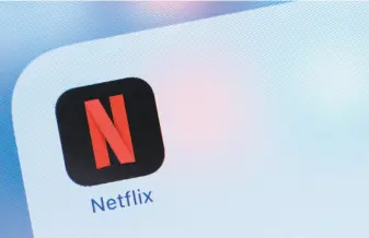  ?? Alastair Pike / AFP / Getty Images ?? Netflix shares plunged more than 12% in afterhours trading on reports of slowing growth.