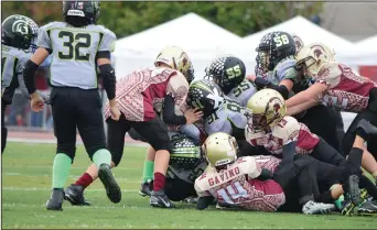  ?? COURTESY PHOTOS ?? Above: A mass of players jump on the pile during the Lodi Titans' loss to Antioch in the NYCFC championsh­ip on Saturday on Tracy. Below left: The Lodi Titans defense makes a tackle during Saturday's game. Below right: Lodi's Zach Fillippini (24)...