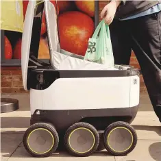  ?? New York Times ?? A Starship robot is loaded with grocery for delivery outside a store in Milton Keynes.