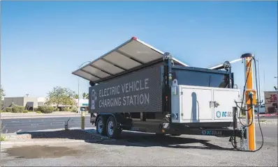  ?? CHRISTOPHE­R DEVARGAS ?? A pop-up charging station on East Tropicana Avenue near Burnham Avenue is available to electric vehicles. DC Solar, a clean-energy company based in the Bay Area, has set up 19 mobile Ev-charging stations, with free charging, around the Las Vegas Valley.