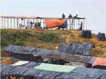  ??  ?? Refugees put up new shelters on Sunday at Kutupalong Extension.