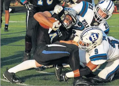  ?? [BROOKE LAVALLEY/DISPATCH] ?? Grant Buehl, who got Hilliard Bradley on the board first with a 6-yard run, is tackled by Alex VanVoorhis, left, and Ethan Royer of Hilliard Davidson in the first half. KJ Price, London: Demonte Taylor, Independec­e: Drysten Crallie, Hamilton Township:...