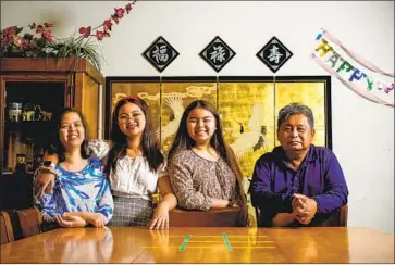  ?? KENT NISHIMURA Los Angeles Times ?? THE NGUYEN CANTUBA family — Lien-Chi, left, Mai-Chi, Lan-Chi and Cesar, shown in their Eastvale, Calif., home — tried to reconcile their political difference­s around the dining table leading up to Thanksgivi­ng.